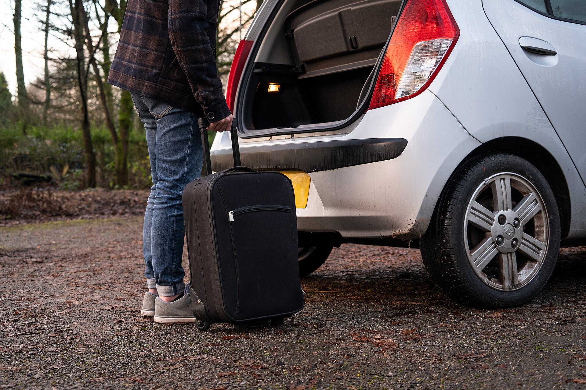 Real luggage being packed into a car boot for JPO shopping bags and family travel load planning